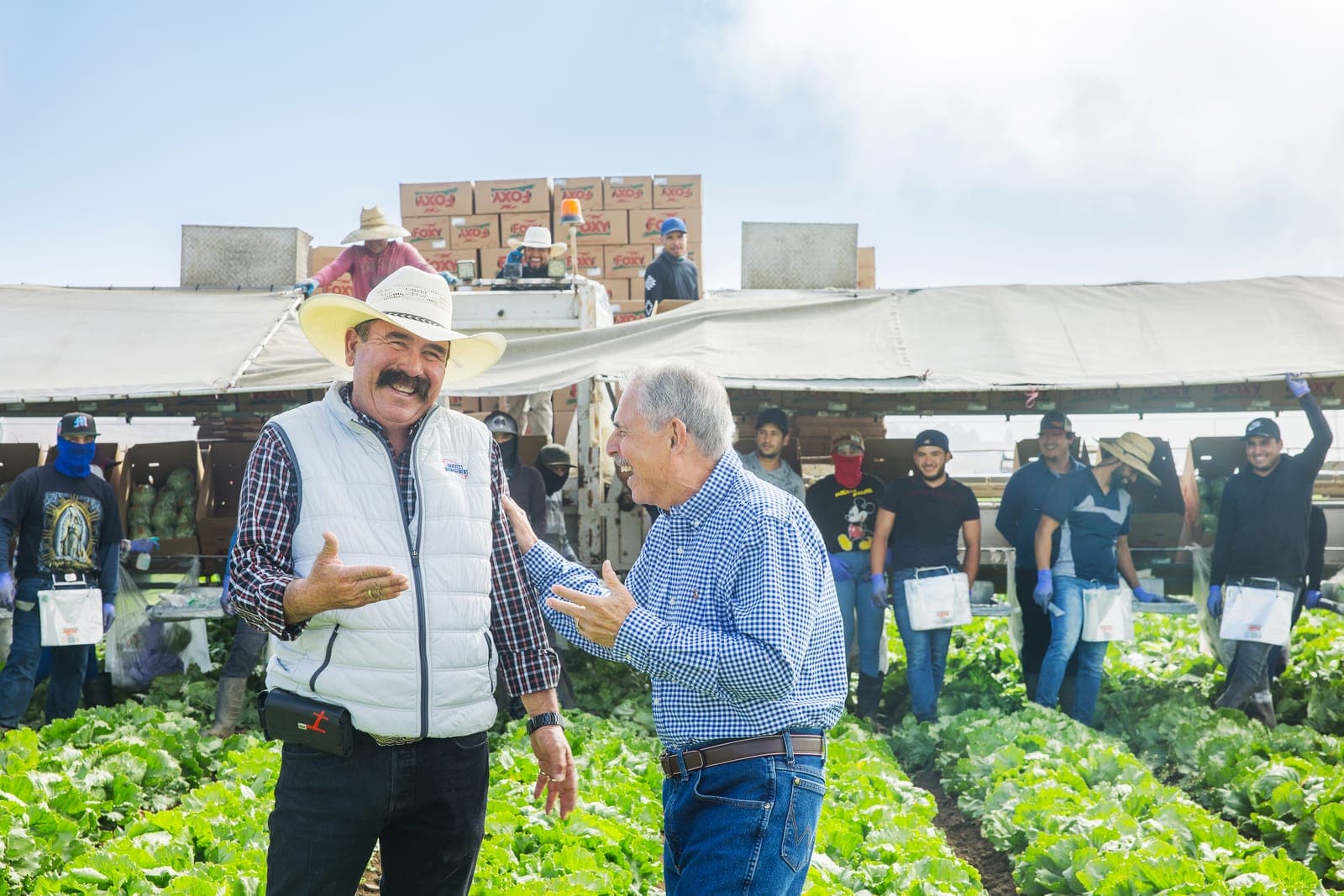 Ranchers talking in the field during a working day