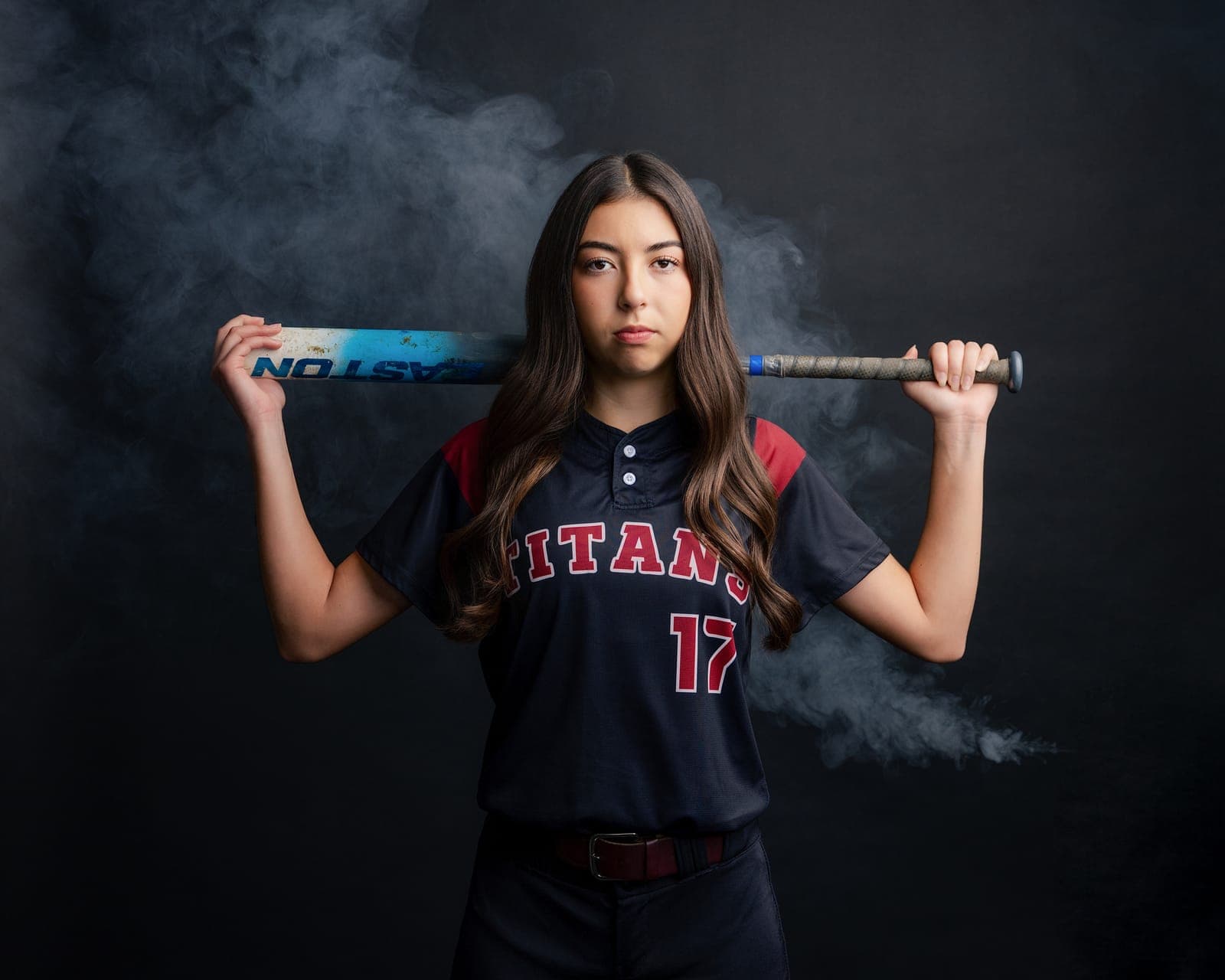 High school senior athlete photographed with her softball bat in the Grover Beach studio by Amy Marlan Photography