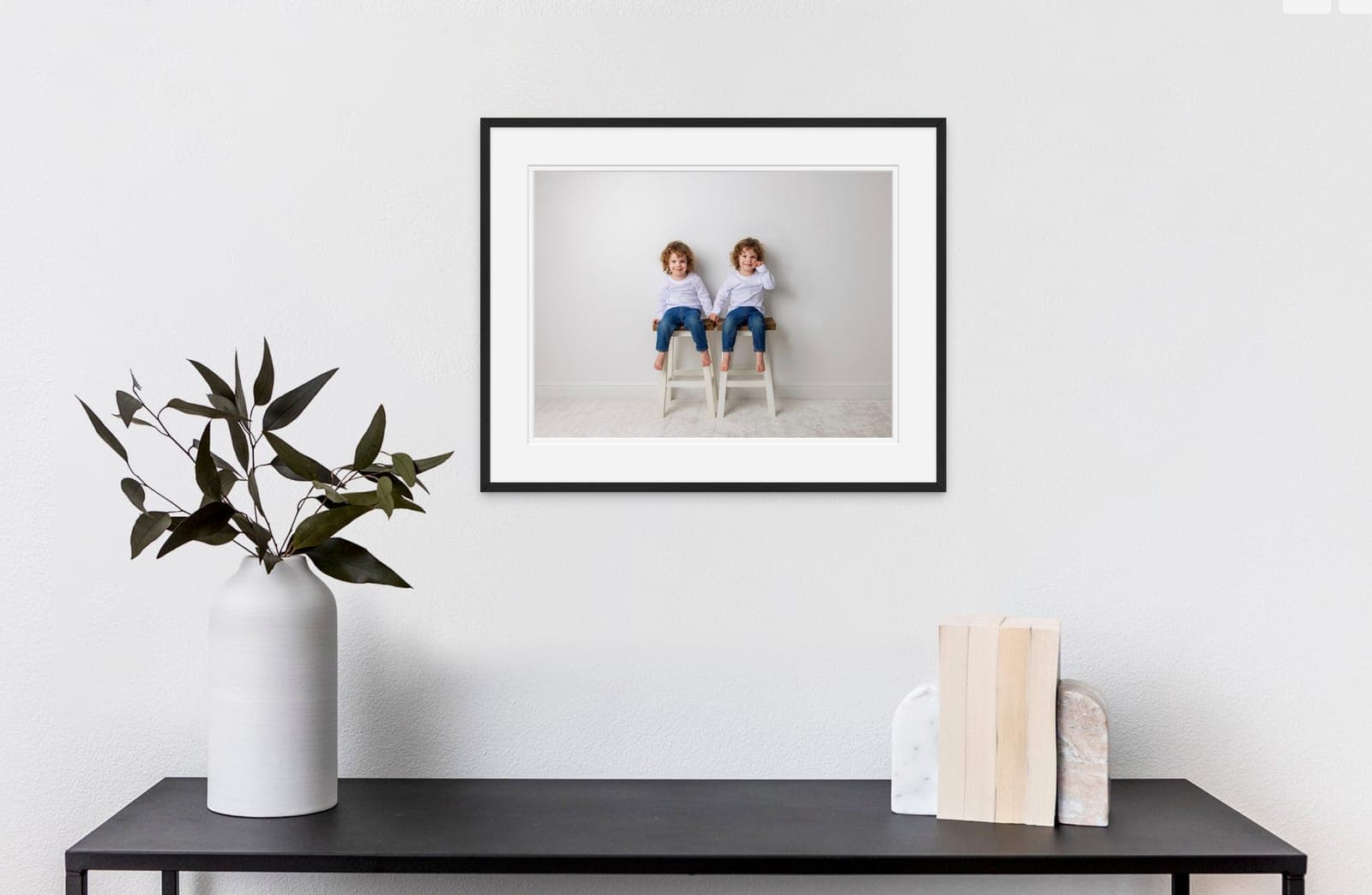 Framed portrait print displayed on a wall in a client's home